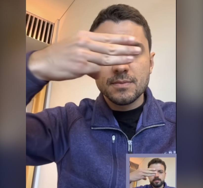 Eduardo Pires holds three fingers in front of face - deepfake passes the fingers test